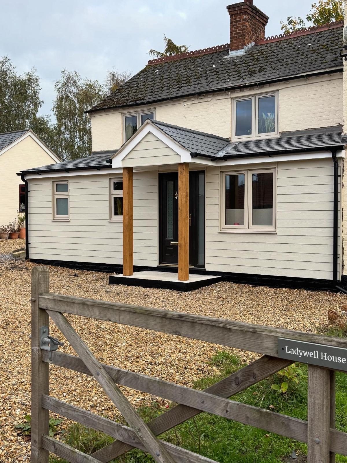 Completed single-storey side extension on a rendered cottage by Thelwall