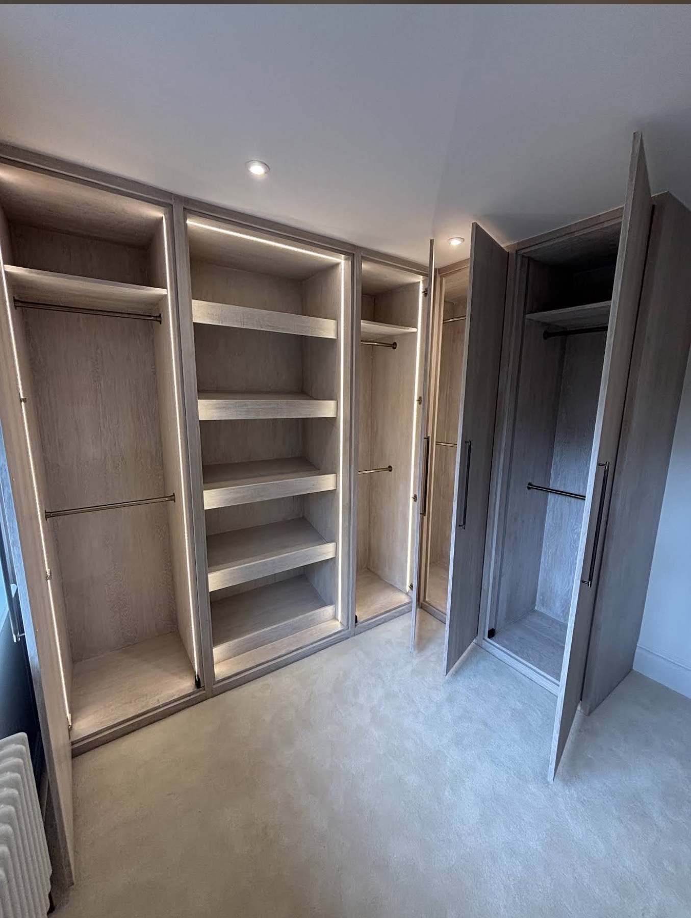 Bespoke walk-in wardrobe with backlit shelves